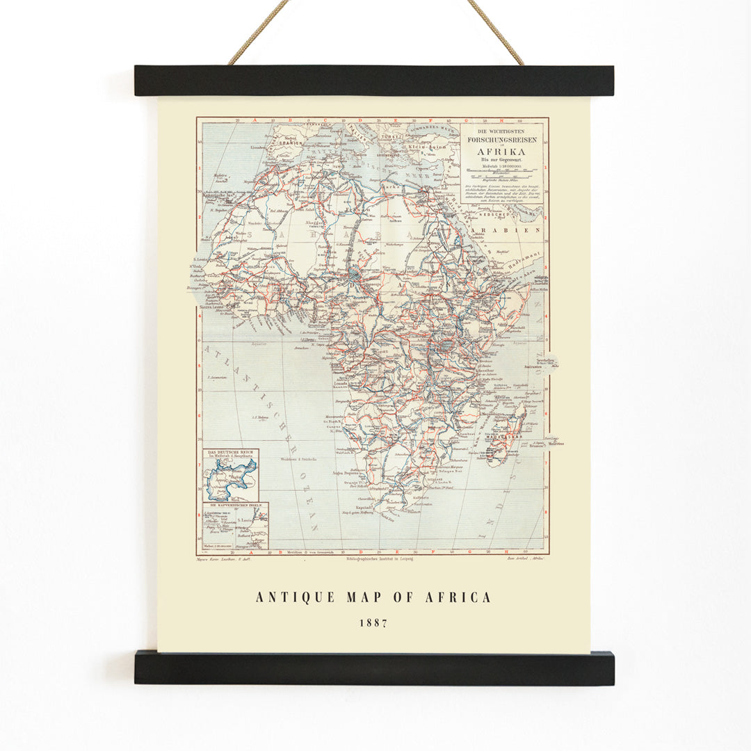 Antique map of Africa by Institute of Liepzig showing exploration routes geographic features and country names wall art poster, with wooden magnetic frame on white background
