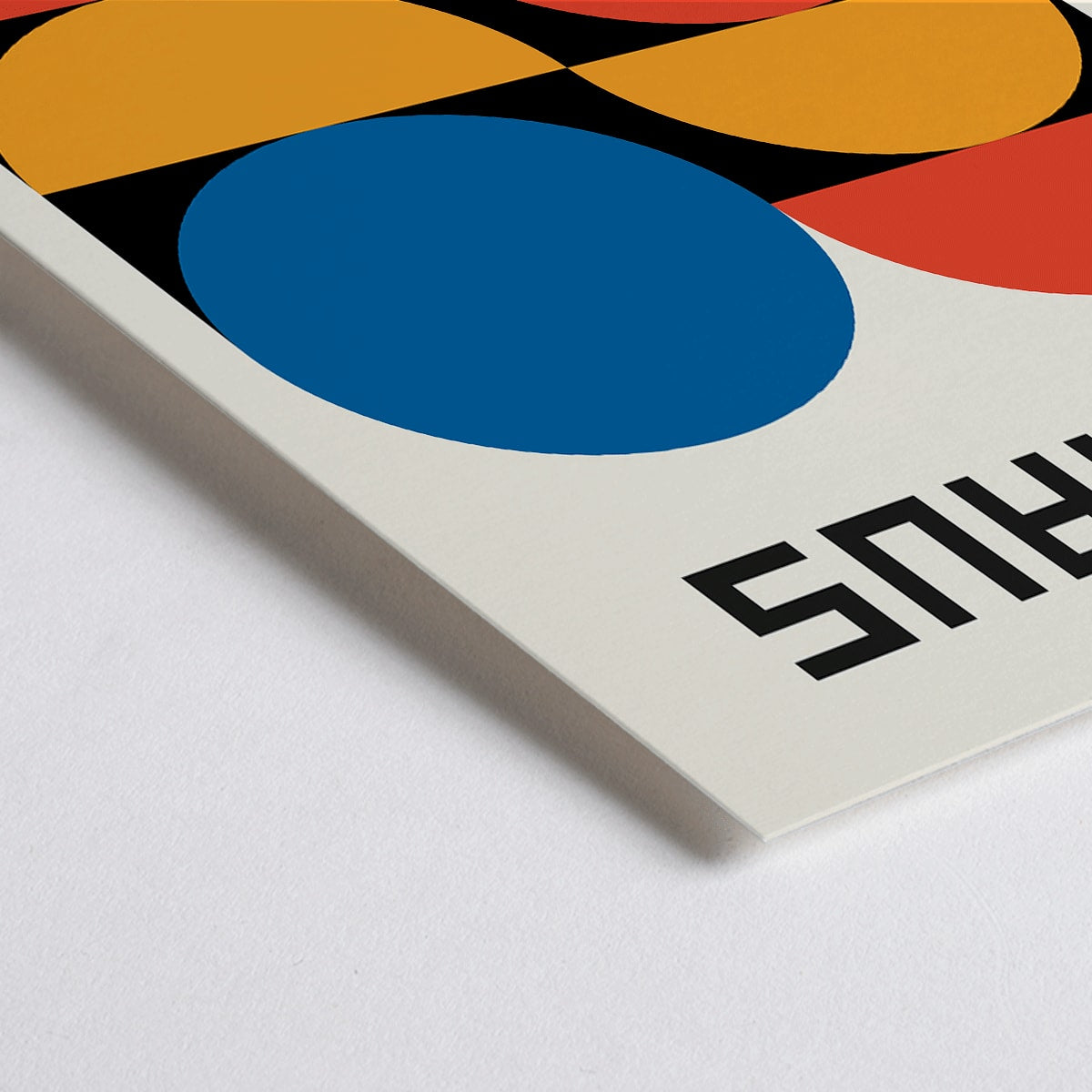 Closeup detail of Bauhaus Poster 18 with bold geometric shapes in red blue and yellow on a white background minimalist design primary colors and Bauhaus text at the top