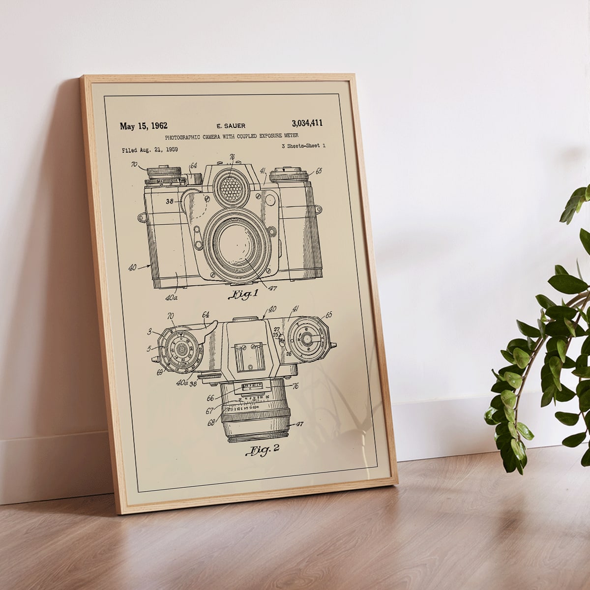 Technical illustration and poster of photographic camera with coupled exposure meter patent by E Sauer showing detailed technical drawings, framed and displayed in modern living room decor