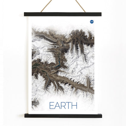 Stunning NASA satellite image of Earth showing snowy mountain ranges and rugged terrain high resolution poster, with wooden magnetic frame on white background