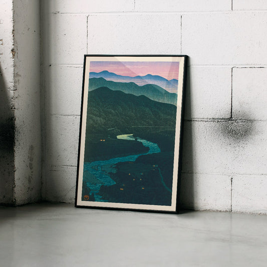 Ecchu Umidani Pass by Kawase Hasui landscape artwork showing mountains and a winding river at dawn and dusk, framed and displayed in home decor