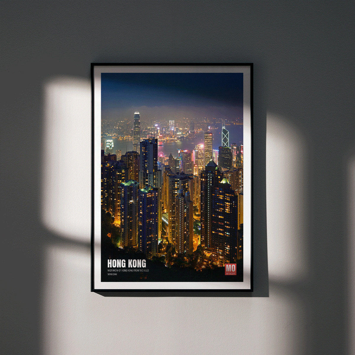 Hong Kong Nightview by Mo Art Gallery featuring a vibrant illuminated city skyline and skyscrapers at night, framed and displayed in modern living room decor