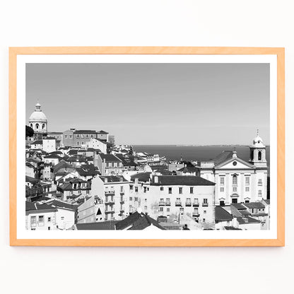 Black and white landscape of Lisbon Old City with historic architecture rooftops and distant sea view poster by Picture 2, framed and displayed in modern living room decor