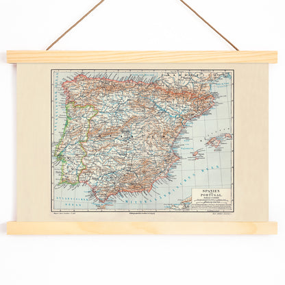 Ancient vintage map of Spain and Portugal with detailed regions and borders by Bibliographic institute of Liepzig poster artwork, with wooden magnetic frame on white background