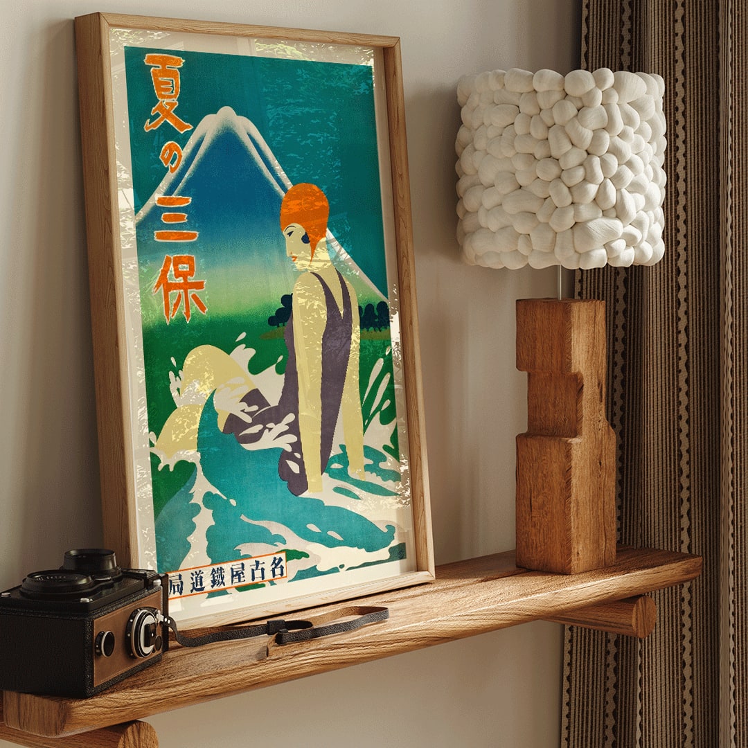 Japanese woman in bathing suit with orange cap sitting in waves at Miho Peninsula with Mount Fuji in background by Nagoya Rail Agency, framed and displayed in home decor