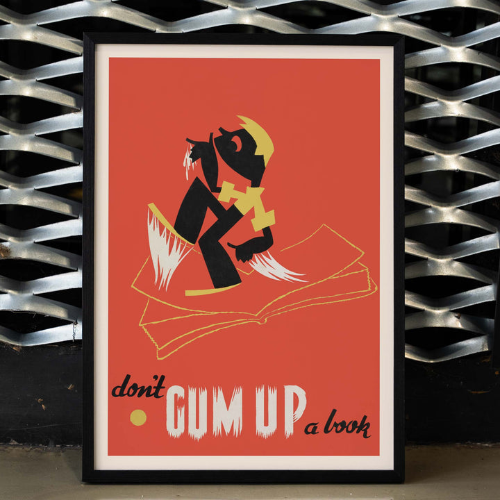 Arlington Gregg Dont gum up a book poster with bold black figure over open book on red background with yellow accents, framed and displayed in home decor