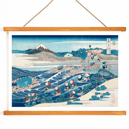Travelers crossing a river with Mount Fuji in the background in Tokaido Kanaya no Fuji by Katsushika Hokusai poster, with wooden magnetic frame on white background