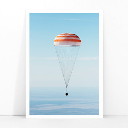 Soyuz MS-02 spacecraft descending with parachute over Kazakhstan NASA poster titled The Soyuz MS-02 spacecraft lands, framed and displayed in modern living room decor