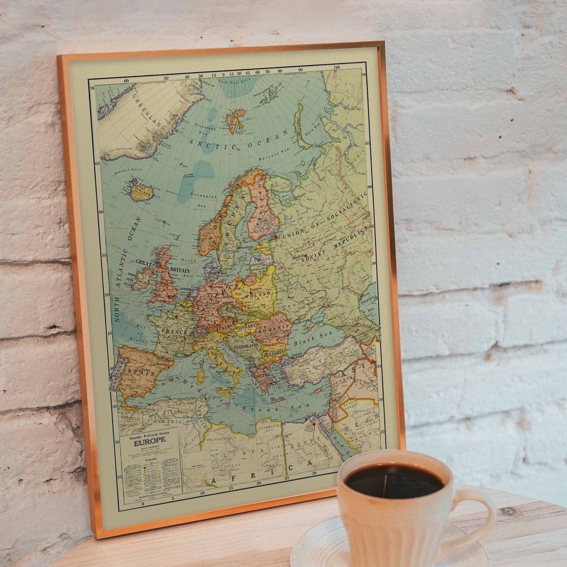 Rand McNally and Company Political Map of Europe poster with detailed continental map, colored borders, seas, and vintage cartographic typography, framed and displayed in modern living room decor