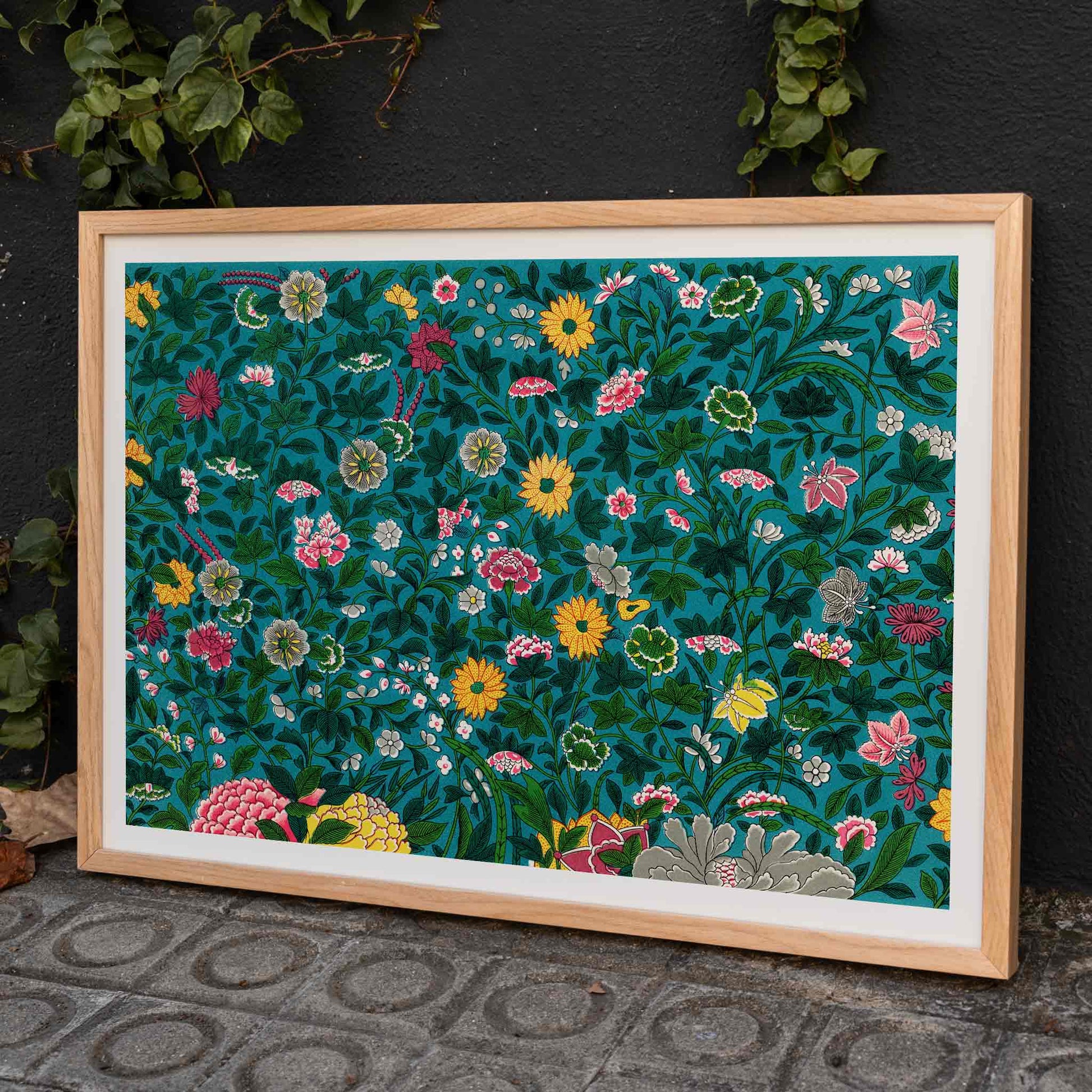 Vibrant floral poster with green botanical pattern by Owen Jones on teal background, framed and displayed in home decor