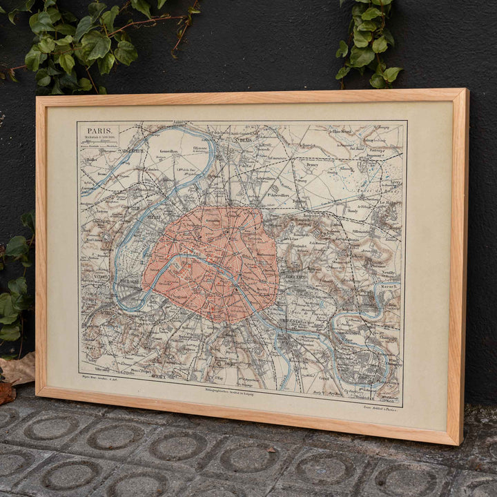 Ancient map of Paris city and surroundings by Bibliographic institute of Liepzig with detailed streets and highlighted city center poster artwork, framed and displayed in home decor