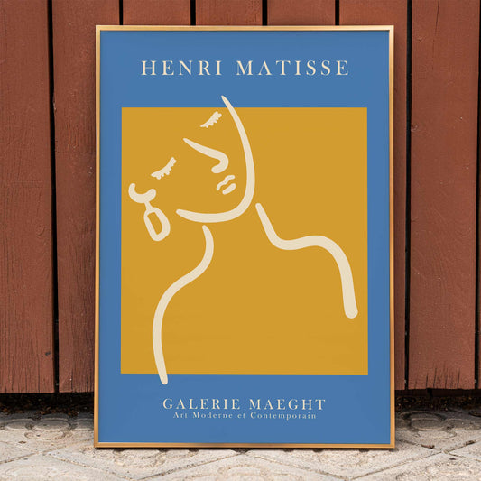 Henri Matisse poster of abstract girl with earring in orange and blue from Galerie Maeght artwork, framed and displayed in home decor