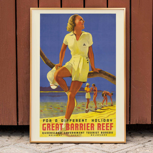 Vintage travel poster by Percival Albert Trompf showing a woman sitting on a branch at the Great Barrier Reef with people enjoying the beach in the background, framed and displayed in home decor