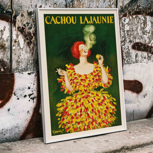 Colorful poster Cachou Lajaunie by Leonetto Cappiello featuring a woman in a vibrant dress with smoke forming a face and holding a cigarette, framed and displayed in home decor