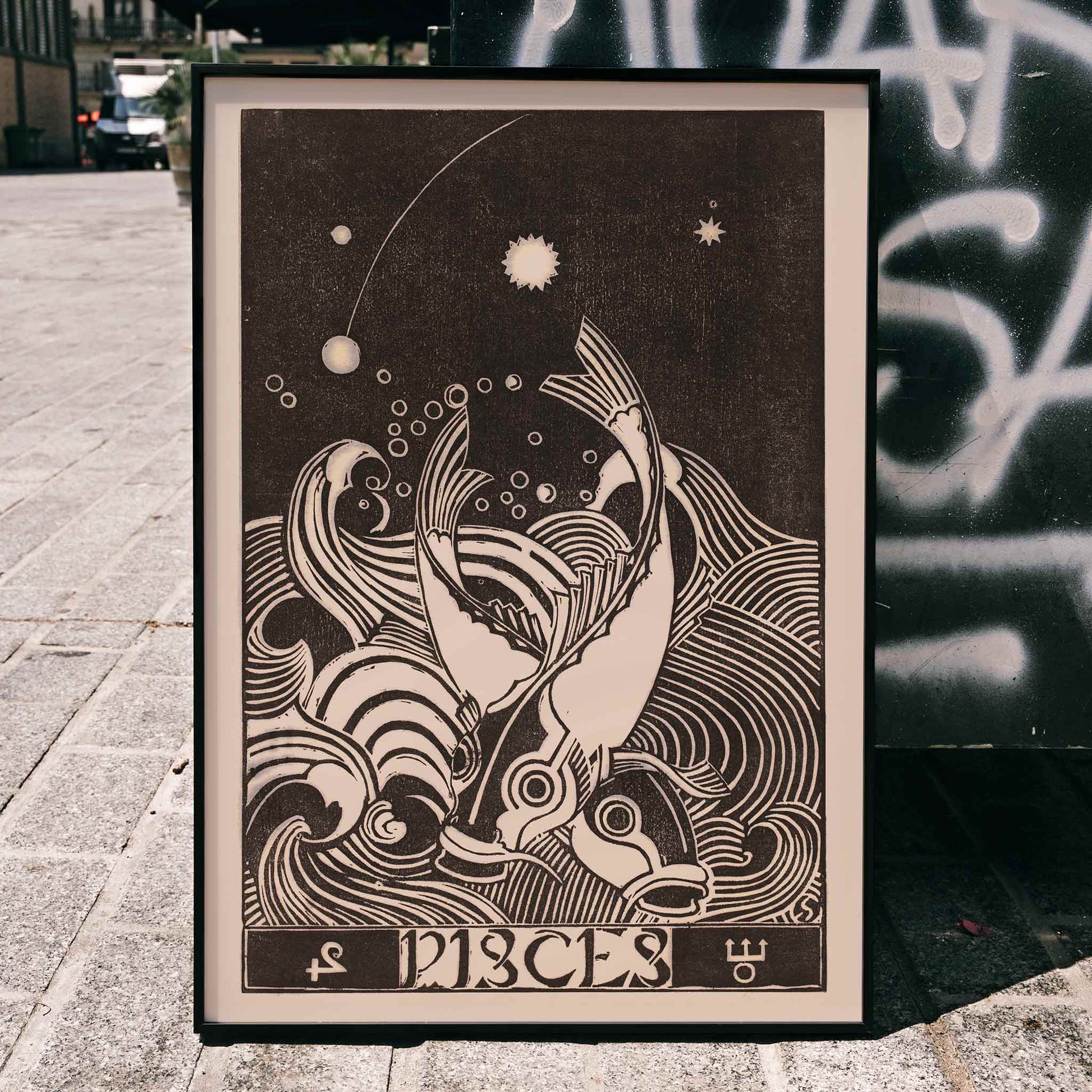 Black and white Pisces zodiac sign illustration with two stylized fish swimming among swirling waves artwork by Henri van der Stok, framed and displayed in home decor