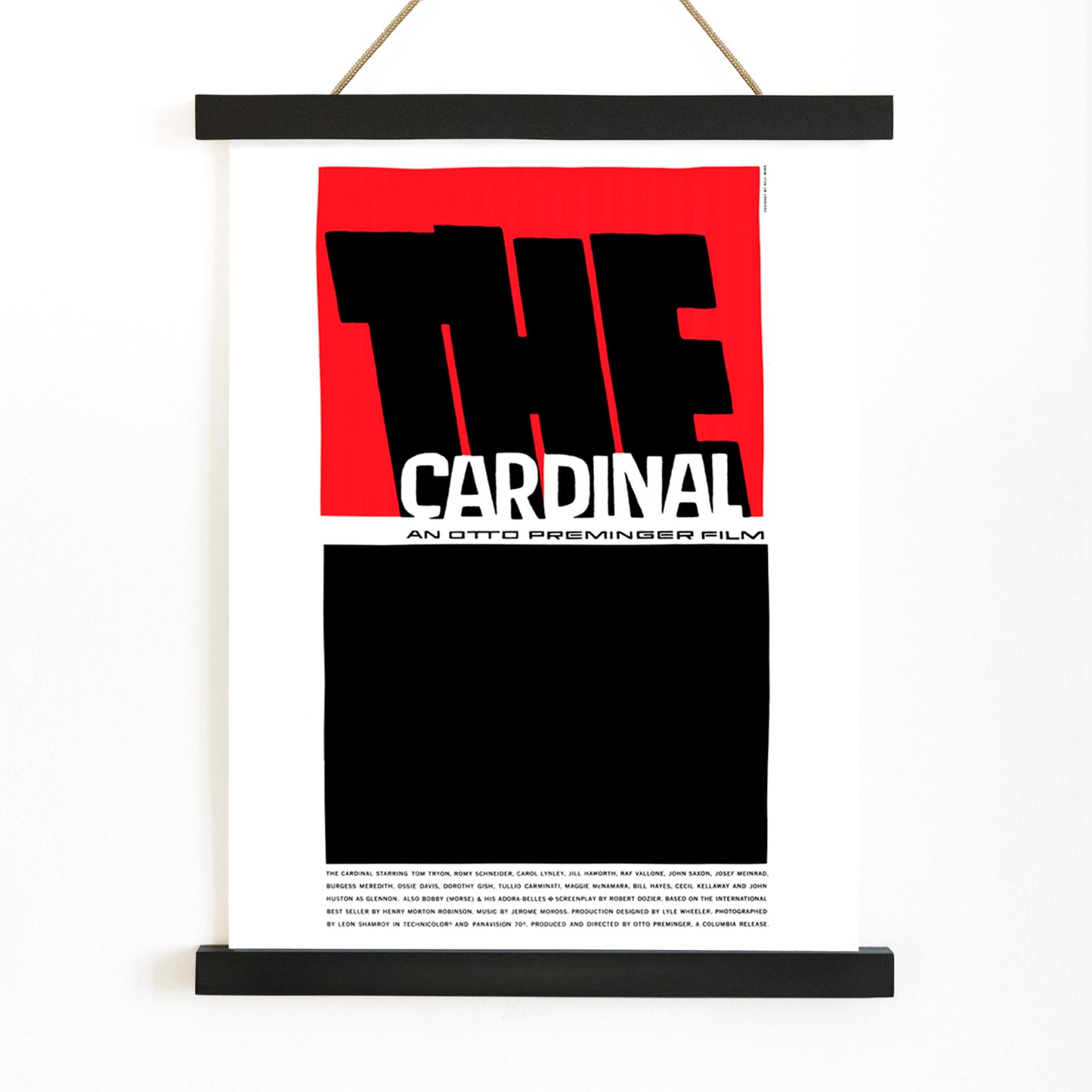 Minimalist graphic design of The Cardinal Movie poster by Saul Bass featuring bold black and red graphics large text and a minimalist style, with wooden magnetic frame on white background