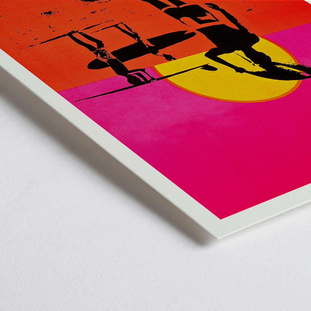 Closeup detail of The Endless Summer poster with surfers carrying boards on a beach at sunset against a stylized sunset backdrop